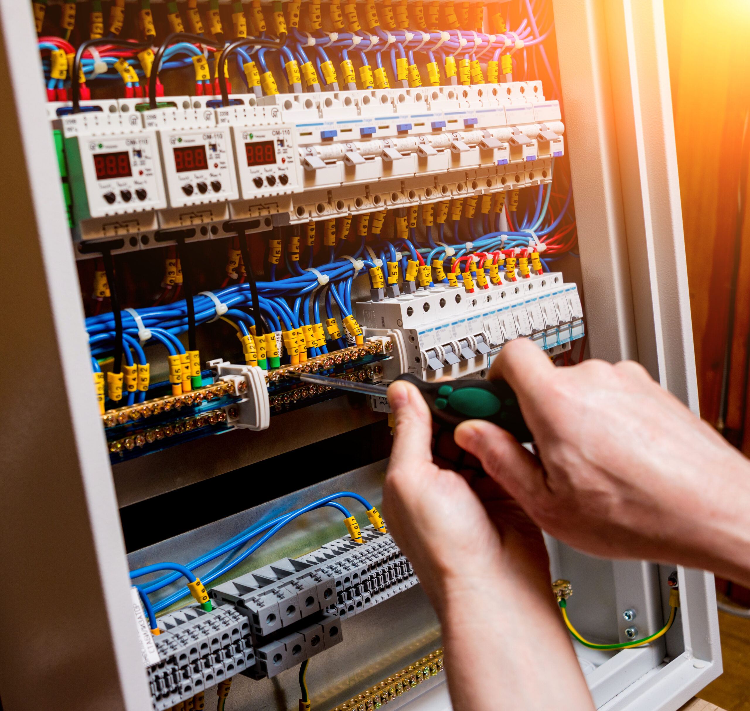 Electrician safely repairing electrical panel in Kootenai County, WA